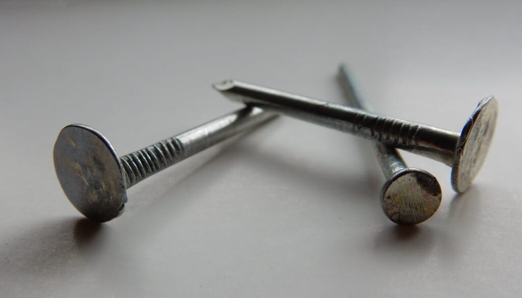 3 flat nails on a white surface