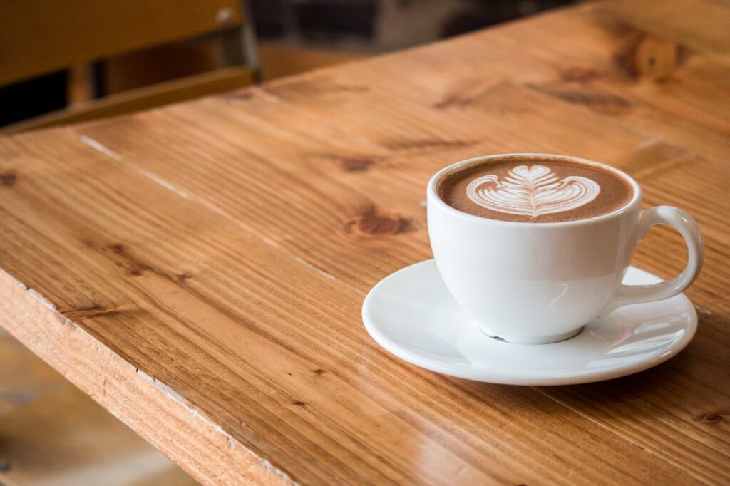 A wooden coffee table and a cup of coffee on it